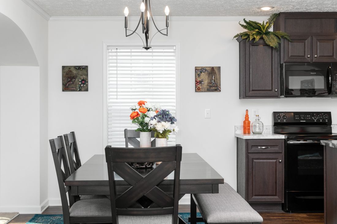 The 1321 CLASSIC Dining Area. This Manufactured Mobile Home features 4 bedrooms and 2 baths.